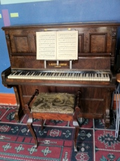 upright piano with piano stool